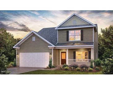 Charming two-story home with a covered front porch and attached two-car garage at 1249 Turkey Trot Rd, Wendell, NC 27591
