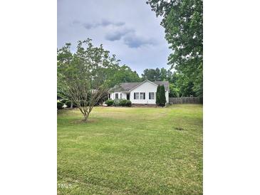 Charming single story home with a spacious lawn and mature shade trees at 1360 Honeycutt Rd, Willow Springs, NC 27592