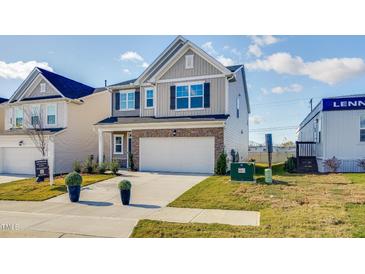 Charming two-story home featuring a two-car garage and stone accents at 160 N Finley Landing Pkwy, Smithfield, NC 27577