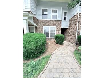 Charming two-story condo with stone accents and a well-manicured front walkway, address 2107 at 2107 Freeport Dr, Cary, NC 27519
