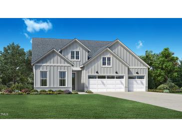 Charming two-story home showcasing light gray siding, a well-manicured lawn, and a convenient three-car garage at 2125 Abbeyhill Dr # 88, Raleigh, NC 27610