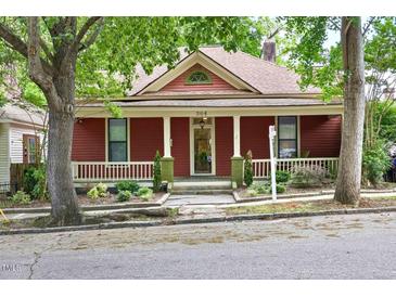 Charming red house with a cozy front porch and well-maintained landscaping at 304 Linden Ave, Raleigh, NC 27601
