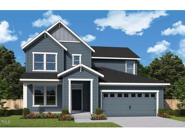 Charming two-story home with a two-car garage, a cozy front porch, manicured landscaping, and beautiful curb appeal at 33 Cozy Hvn, Fuquay Varina, NC 27526