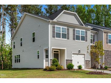 Charming gray two-story home with a one-car garage and well-maintained landscaping at 501 Hazy Hills Ln, Garner, NC 27529