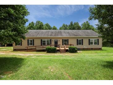 Charming single-story home featuring a wheelchair ramp and landscaped front yard with mature trees at 921 Sweet Raspberry Lane Ln, Lillington, NC 27546