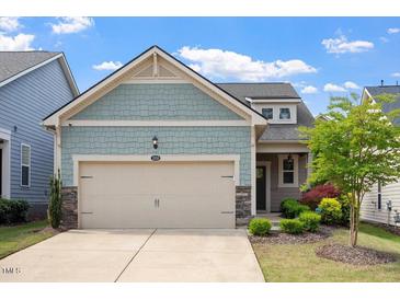 Charming home featuring a two-car garage, stone accents, and delightful landscaping at 1008 Sounding Ln, Durham, NC 27703