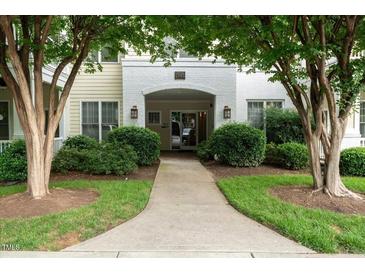 Welcoming entrance with lush landscaping leading to the front door at 1301 Durlain Dr # 103, Raleigh, NC 27614