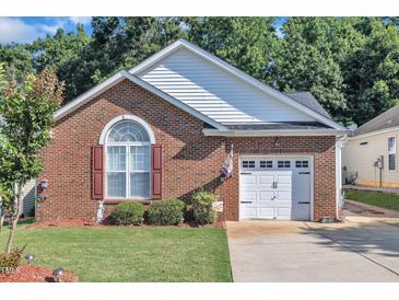 Charming brick home featuring a one-car garage, manicured lawn, and decorative shutters at 133 Marino Pl, Clayton, NC 27527