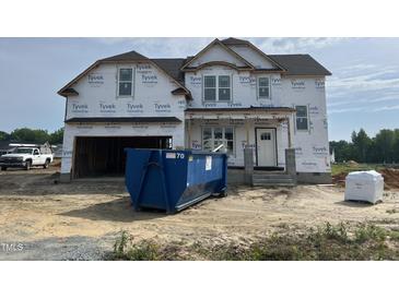 New two-story home with Tyvek wrap, covered entrance, and an attached two-car garage at 151 Retreat Run, Smithfield, NC 27577