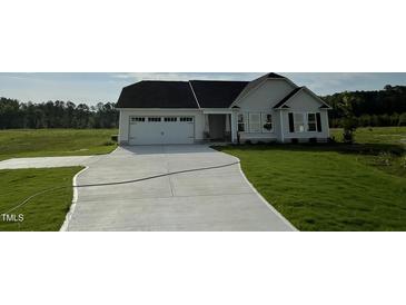 Charming single-Gathering home featuring a two-car garage and a well-manicured lawn at 180 Tulipfield Way, Benson, NC 27504
