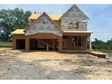 Under-construction home featuring a two-story design with a framed facade, showcasing future architectural details at 209 Atkins Rd, Cameron, NC 28326