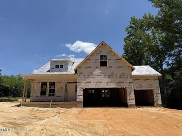 Unfinished new construction home featuring a covered porch and modern roof design at 235 Atkins Rd, Cameron, NC 28326