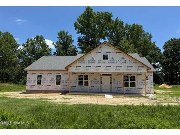 Exterior of a new construction home showcasing the facade and covered entrance, surrounded by a green lawn at 275 Atkins Rd, Cameron, NC 28326