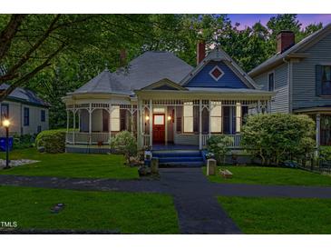 Charming historic home with a classic wraparound porch and lush green lawn at 517 N East St, Raleigh, NC 27604