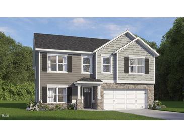 Two-story home boasts a two-car garage, gray siding, a stone foundation, and black shutters at 809 Comice Pear Way, Willow Springs, NC 27592