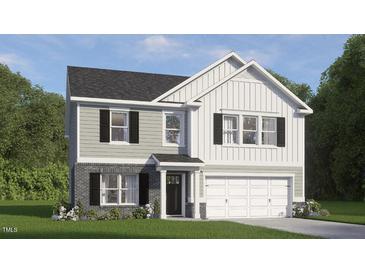 Charming two-story home showcasing a mix of gray siding and brick accents, plus a two-car garage at 812 Comice Pear Way, Willow Springs, NC 27592