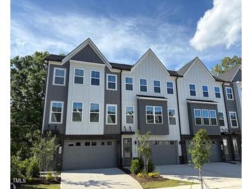 Stylish townhome with gray and white siding and individual garages at 1003 Regalia Rd # 33, Durham, NC 27713
