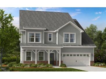Charming two-story home featuring a covered porch, gray siding, and a two-car garage at 1020 Dillon Lake Dr, Knightdale, NC 27545