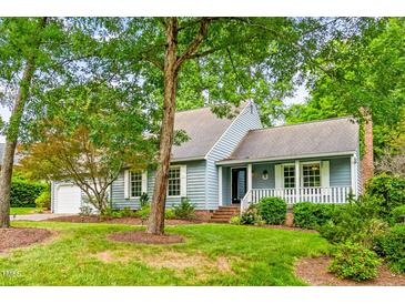Charming home with mature trees, a brick chimney, and a well-manicured lawn at 318 Fieldstone Dr, Burlington, NC 27215