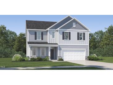Charming two-story home with stone accents, gray siding and a well-manicured lawn at 540 Morning Light Dr, Angier, NC 27501