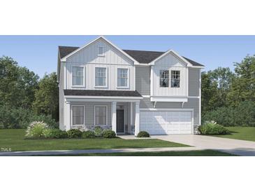 Charming two-story home with gray and white siding, stone accents, and a well-manicured lawn at 544 Morning Light Dr, Angier, NC 27501