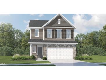 Two-story home with stone accents, a two-car garage, and a well-manicured lawn at 549 Morning Light Dr, Angier, NC 27501