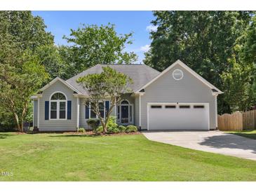 Charming one-story home with gray siding, blue shutters, manicured lawn, and attached two car garage at 6 Danesfield Ct, Durham, NC 27707
