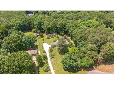 Expansive aerial view of a home surrounded by lush greenery and a long driveway at 8133 Holly Forest Rd, Wake Forest, NC 27587