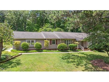 Charming single-story home featuring well-maintained landscaping and a welcoming walkway at 8133 Holly Forest Rd, Wake Forest, NC 27587