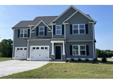 Beautiful two-story home with a well-manicured lawn and a two-car garage at 111 Bonsai Way, Four Oaks, NC 27524