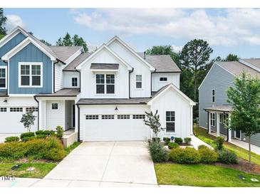 Charming two-story home with a white facade, black trim, and a two-car garage at 1240 Gemfor St, Durham, NC 27703