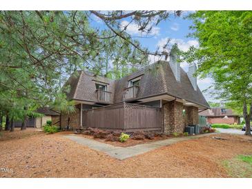 Brick townhouse with two stories, fenced porch, dormer windows, and mature landscaping at 127 Finley Forest Dr, Chapel Hill, NC 27517