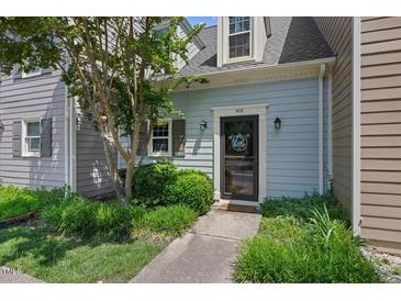 Charming home featuring a welcoming front door with a decorative wreath and landscaped yard at 1602 Township Cir, Raleigh, NC 27609