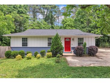 Charming single-story home with a freshly landscaped front yard and a bright red front door at 1717 Martin Luther King Jr Blvd, Raleigh, NC 27610
