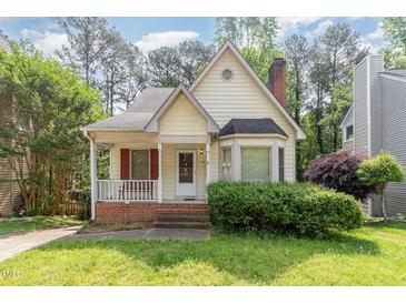 Charming home showcasing a quaint front porch and well-maintained yard at 1720 Kingston Heath Way, Raleigh, NC 27604