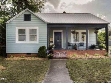 Charming single-story home featuring a covered front porch and well-maintained lawn at 200 S Pettigrew St, Raleigh, NC 27610