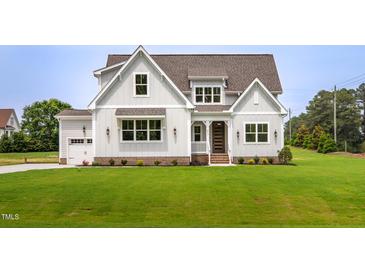 Charming two-story home with a well-manicured lawn and inviting front entrance at 2617 Packhouse Rd, Zebulon, NC 27597