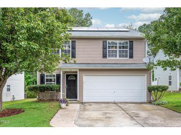 Charming two-story home with a well-maintained lawn, two-car garage, and solar panels at 313 Weeping Willow Dr, Durham, NC 27704