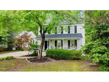 Charming two-story home with a inviting front porch and mature landscaping, offering a warm and welcoming curb appeal at 3541 E Jameson Rd, Raleigh, NC 27604