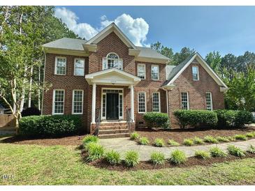 Beautiful brick home with lush landscaping and a welcoming front porch at 4412 Thistlehill Ct, Raleigh, NC 27616