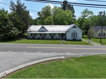 Charming vintage home featuring a covered front porch and quaint architectural details at 522 Providence Rd, Roxboro, NC 27573