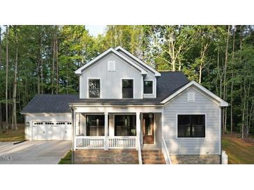 Charming two-story home with a covered porch and attached two car garage at 5491 Silk Hope Gum Springs Rd, Siler City, NC 27344