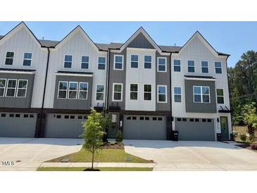 Attractive townhouse exteriors feature varied designs, colors, and attached garages at 1002 Regalia Rd # 2, Durham, NC 27713