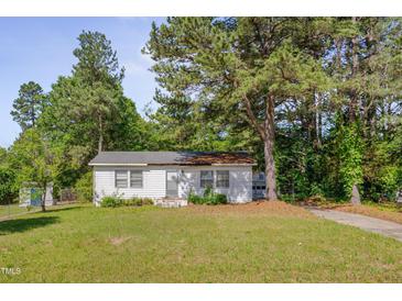Charming single-story home with a white exterior and a well-manicured lawn at 1109 N Pinkston St. St, Henderson, NC 27536