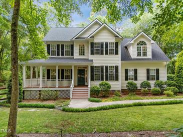 Charming two-story home with a welcoming front porch and lush landscaping at 118 Cavendish Ct, Hillsborough, NC 27278