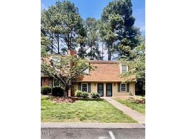 Inviting exterior featuring lush landscaping and a charming facade at 141 Jones Franklin Rd # G, Raleigh, NC 27606