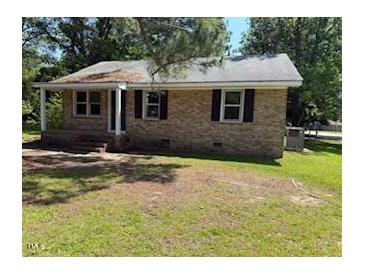 A charming brick home with a well-maintained lawn and inviting front porch at 1525 Hargrove St, Rocky Mount, NC 27801