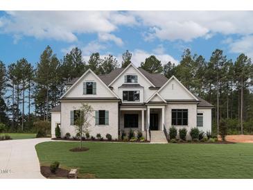 Stunning home with a manicured lawn and inviting entrance, perfect for curb appeal at 25 Alex Farm Ct, Zebulon, NC 27597