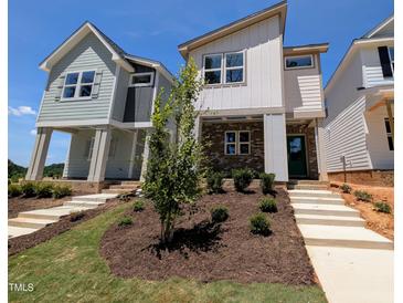 Charming new construction with inviting brick and siding exterior and newly installed front yard landscaping at 330 Cottage Hill Way, Knightdale, NC 27604