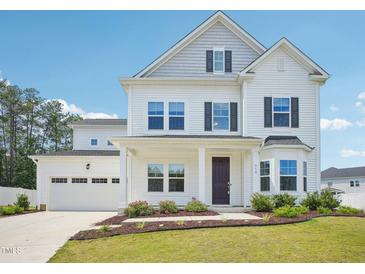 Beautiful two-story home with a well-kept lawn and an attached two car garage at 514 Bonville Ct, Fuquay Varina, NC 27526